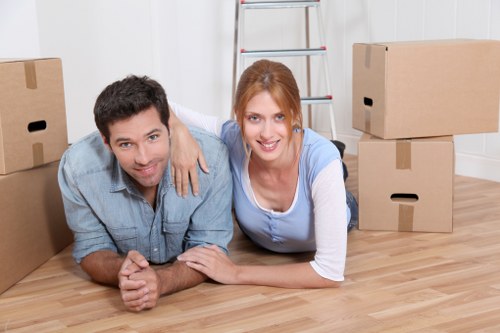 Professional movers in Queens Park handling packed boxes